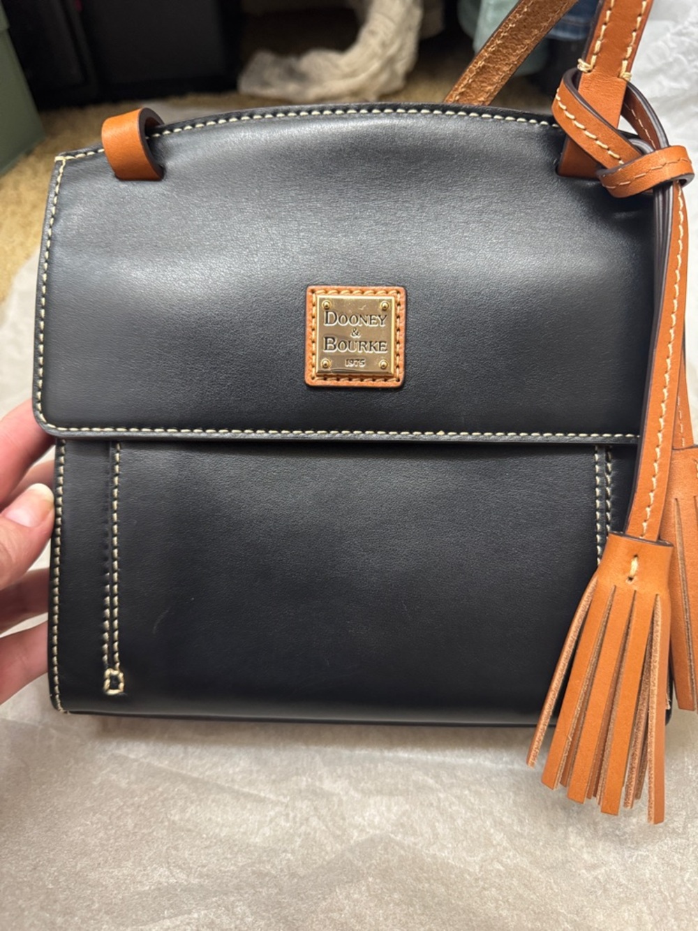 Dooney & Bourke Black Leather Crossbody with Brown Trim and Gold Plaque
